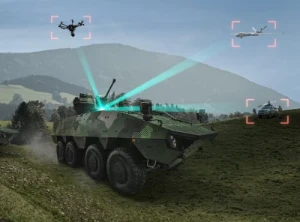 An armored military vehicle on grassy terrain emits blue targeting beams at a drone and an aircraft in the sky, with distant vehicles and mountains in the background. Red target markers highlight the drone, aircraft, and another vehicle.