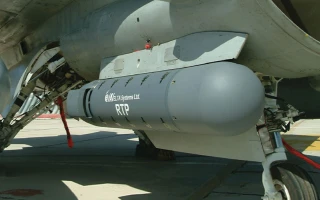 Close-up view of an aircraft’s undercarriage, showing an Elbit Systems Ltd. RTP pod mounted beneath the wing, with the aircraft parked on a concrete surface.