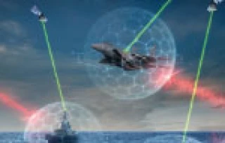 A jam resistant fighter jet soars above the ocean, with a warship below. Digital shields and green/red laser beams link the jet, ship, and satellites, showcasing advanced military technology.