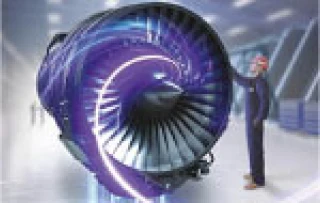 A person in safety gear stands next to a large, futuristic jet engine with glowing purple and blue lights, inside a bright, modern industrial facility.