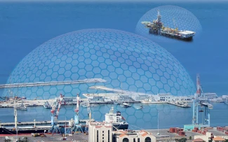 A coastal industrial port with warehouses, cranes, and ships, covered by a large transparent hexagonal dome. Farther out at sea, an oil platform is covered by a similar, smaller dome structure.