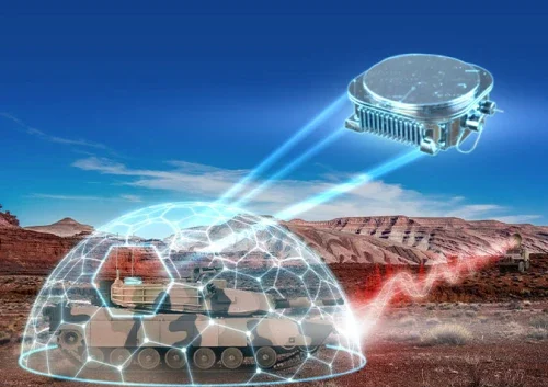 A military vehicle in a desert is protected by a blue, dome-shaped ADA-O digital shield. Above it, a satellite device emits beams toward the vehicle, illustrating advanced defence technology. Rocky hills and a clear sky form the background.