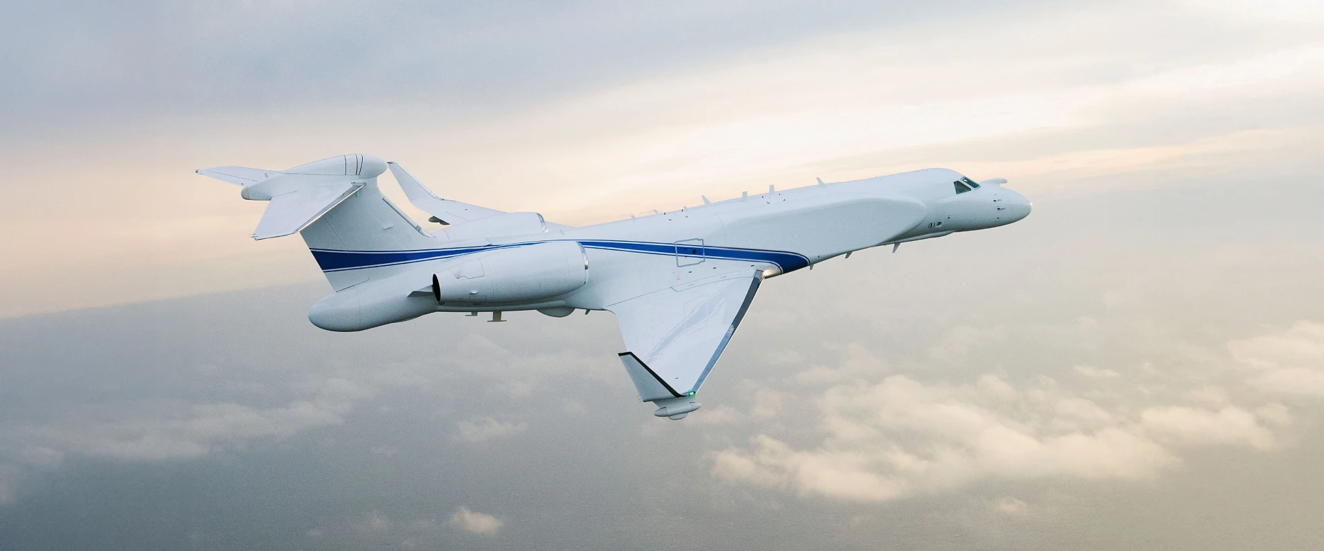 A white surveillance aircraft with blue stripes and surveillance system flies above the clouds against a soft, overcast sky.