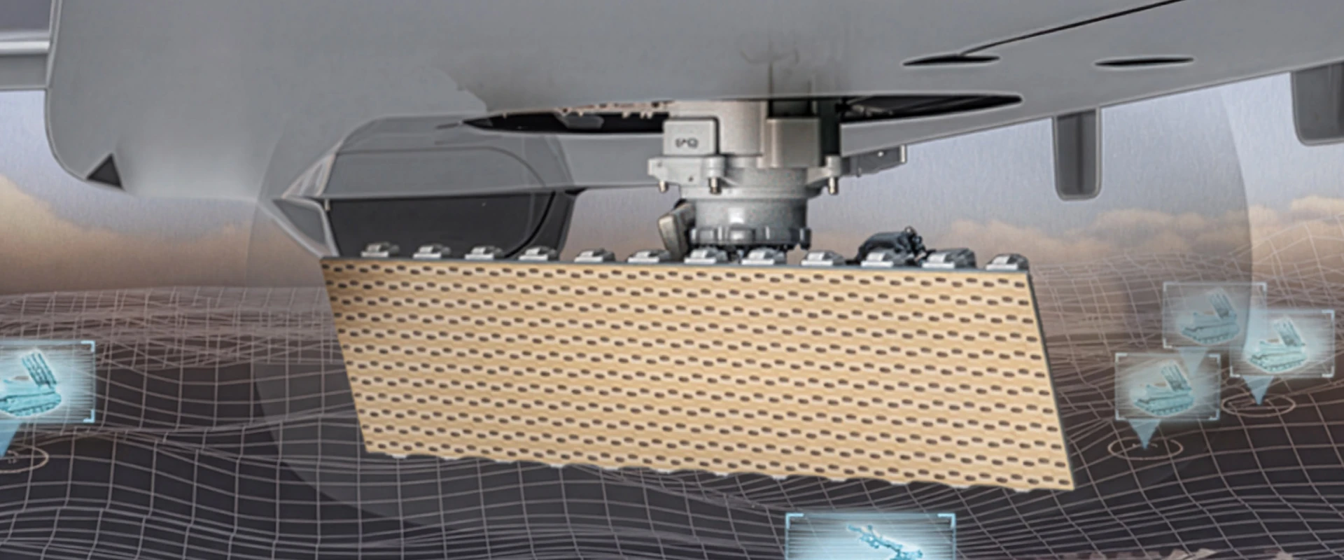 A close-up view of a ground surveillance radar or sensor array mounted under an aircraft, with digital graphics and grids in the background illustrating data analysis or detection technology.
