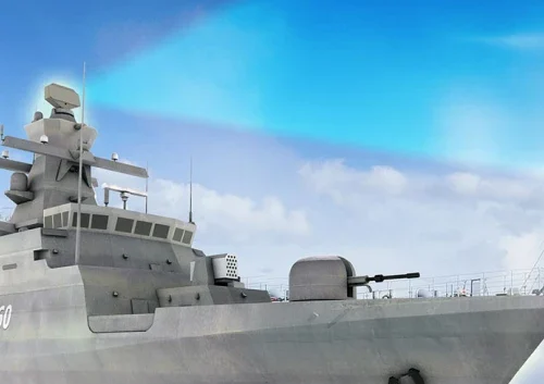 A close-up view of a modern navy warship under a partly cloudy blue sky, showing advanced AESA radar equipment, antennas, and a deck-mounted gun at the front.
