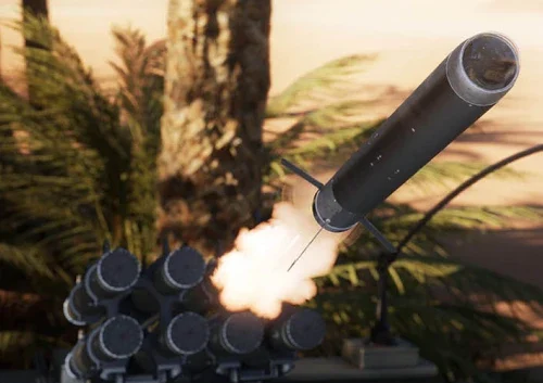 A close-up of an anti tank missile being launched from a multi-missile launcher, with flames and smoke visible, set outdoors amid trees and greenery in the background.