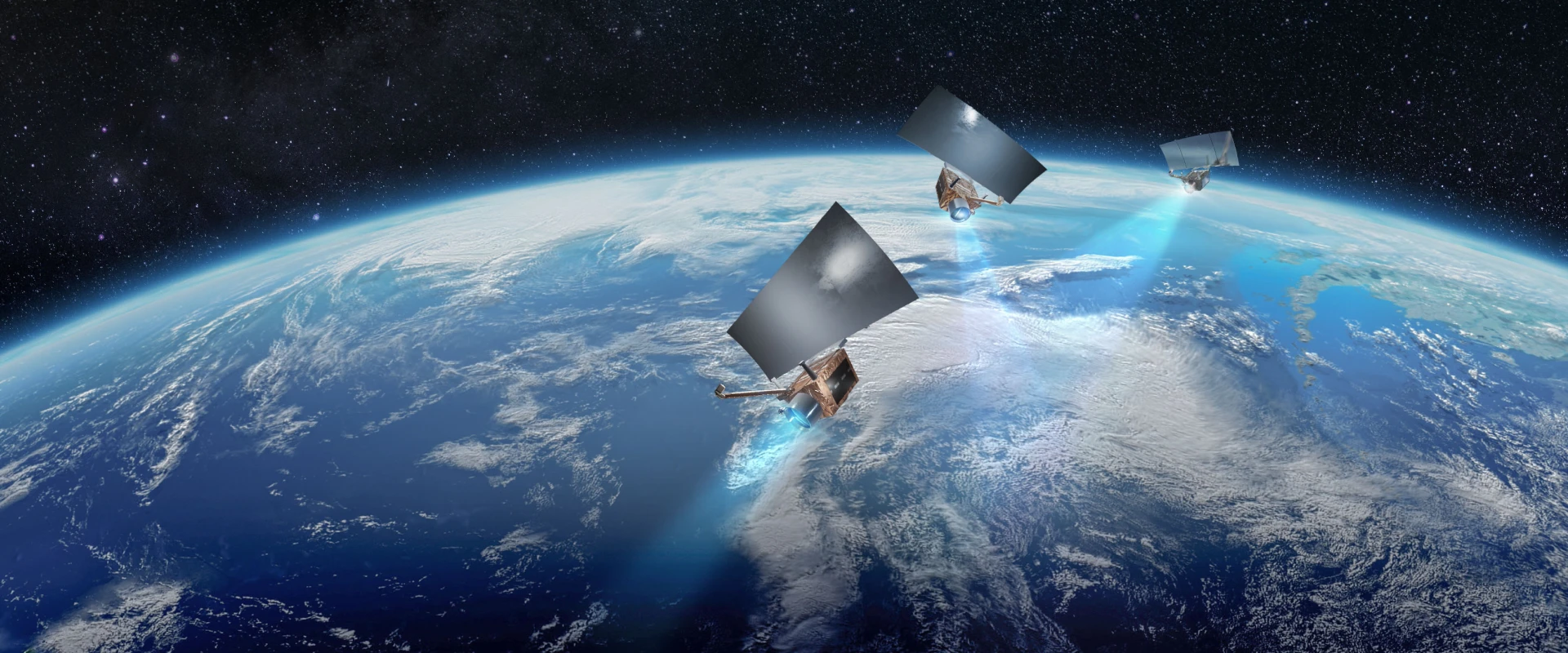 Three OptSAR 550 satellites with large solar panels orbit above Earth, emitting blue beams toward the planet, with clouds and oceans visible below and the darkness of space in the background.
