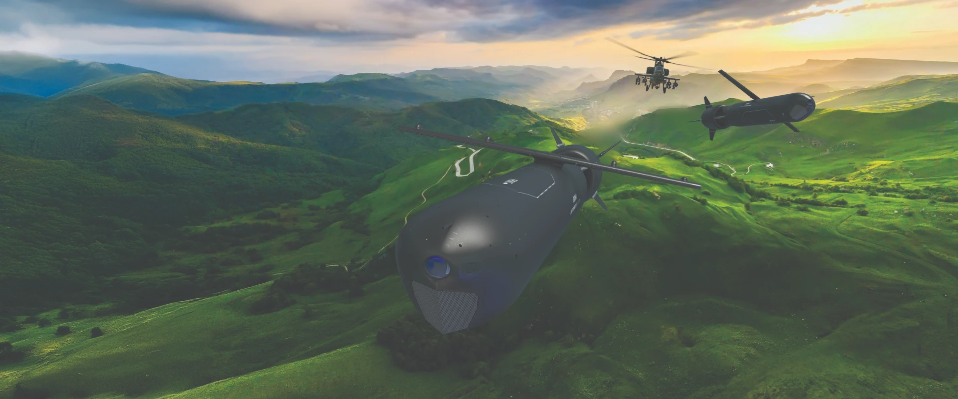Aerial view of two unmanned military drones and a surface cruise missile flying over green hills at sunset, with mountains in the background and a winding road visible below.