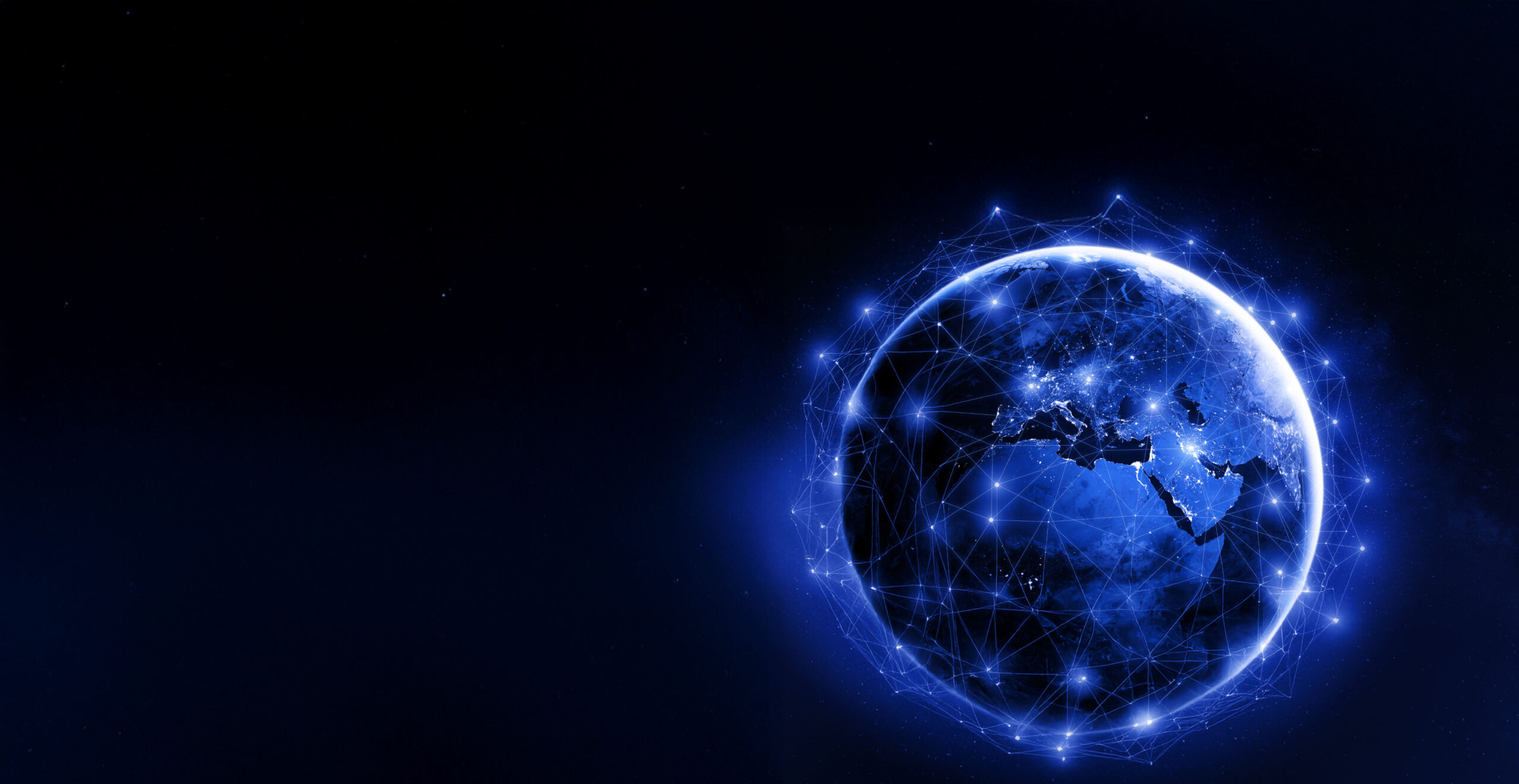 A digital rendering of Earth glowing blue against a dark background, with visible network lines and connection points encircling the planet, symbolizing global connectivity and technology.
