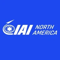 White logo for IAI North America on a blue background. The logo includes stylized text and a circular emblem with a star and arrow.
