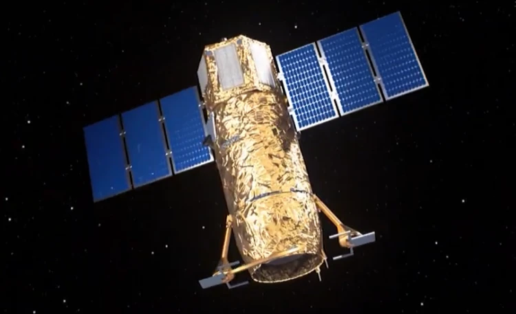 A gold-foil-wrapped multi mission satellite with blue solar panels floats in the blackness of space, gathering intelligence with no stars visible in the background.