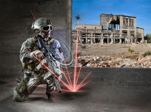 A soldier in modern combat gear kneels inside a building, holding a rifle equipped with a tactical identification device emitting digital red laser effects. Outside, a damaged, abandoned structure is visible under a clear blue sky.
