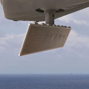 A close-up of a Canadian search and rescue aircraft-mounted radar array, positioned under a wing, with the ocean and distant ships visible in the background.